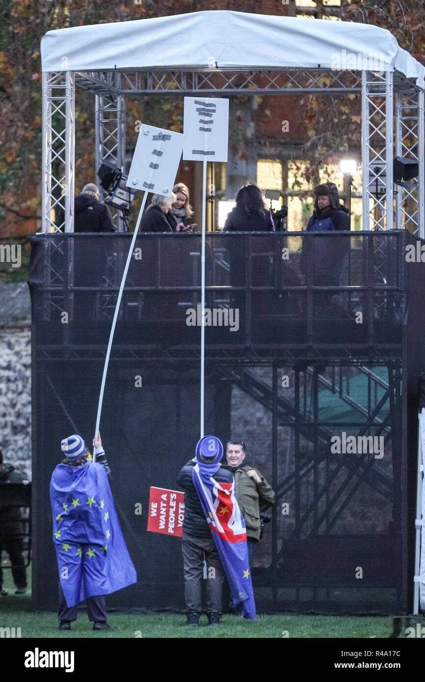Westminster, London, 26th Nov 2018. SODEM founder Steve Bray, often referred to as the 'Shouty Man', and a fellow activist have mounted their placards onto poles to ensure they are seen in TV coverage from the newly erected media platforms at Victoria Tower Gardens. Anti-Brexit Protesters from SODEM (Stand of Defiance European Movement) rally outside the Houses of Parliament and near media reporters and crews at College Green in Westminster. Credit: Imageplotter News and Sports/Alamy Live News Stock Photo