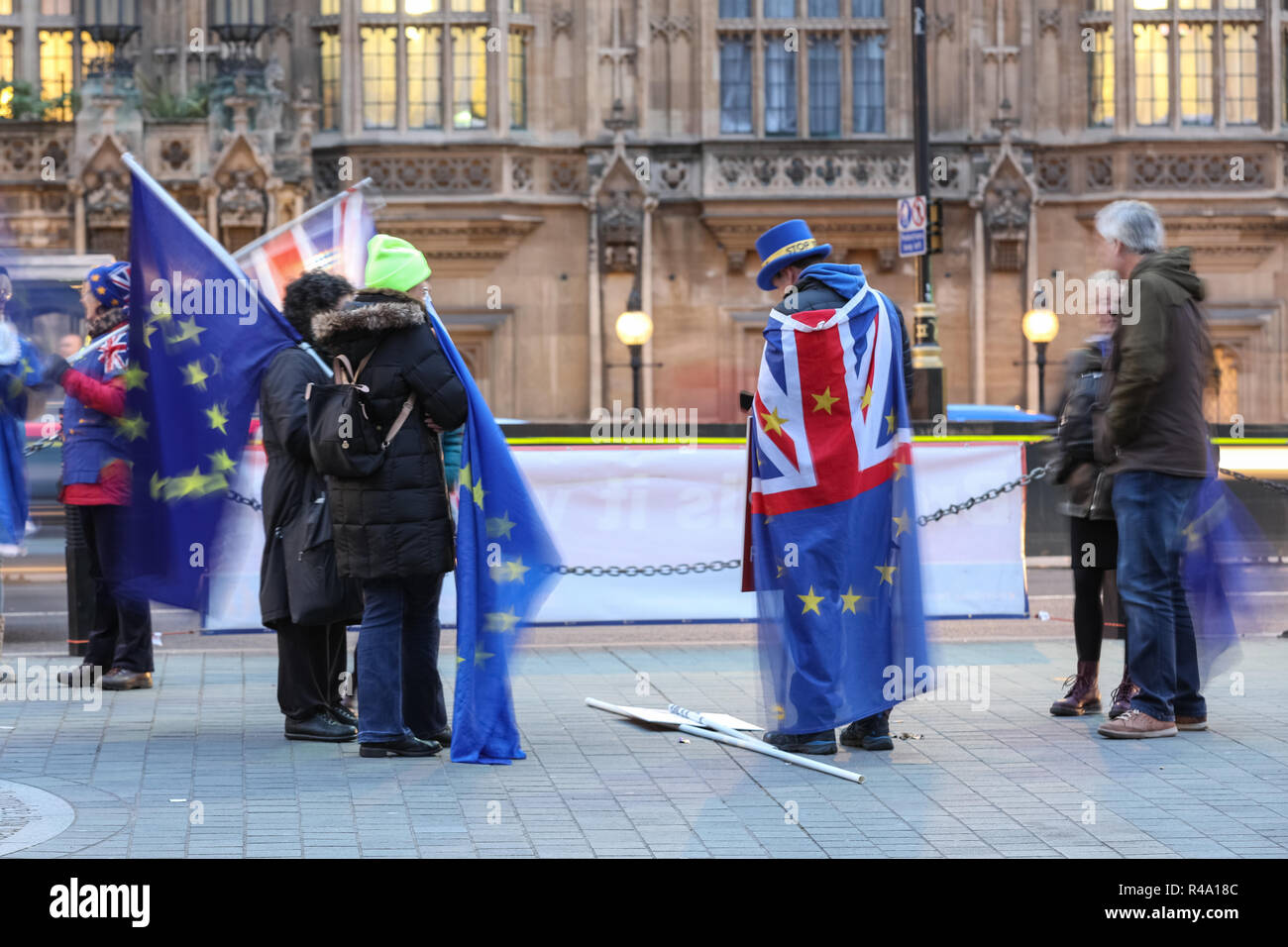 Westminster, London, 26th Nov 2018. SODEM founder Steve Bray, often referred to as the 'Shouty Man', stands with his placards as fellow protesters wave flags around him . Anti-Brexit Protesters from SODEM (Stand of Defiance European Movement) rally outside the Houses of Parliament and near media reporters and crews at College Green in Westminster. Credit: Imageplotter News and Sports/Alamy Live News Stock Photo