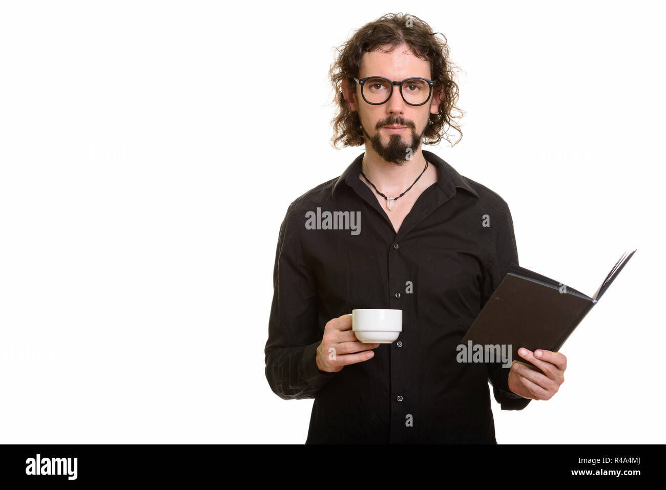 Handsome Caucasian man holding book and coffee cup Stock Photo
