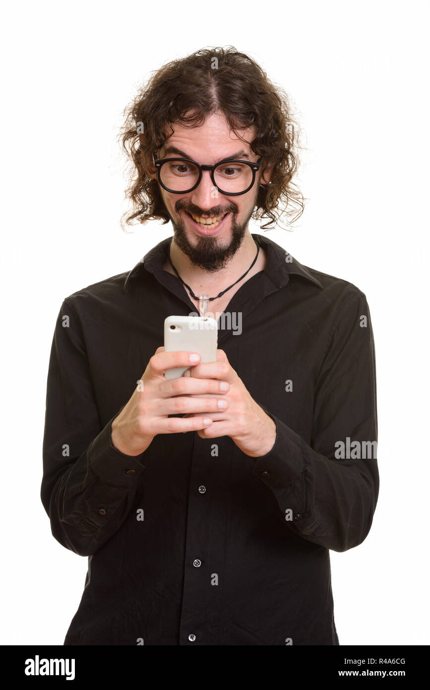 Happy handsome Caucasian man laughing while using mobile phone  Stock Photo