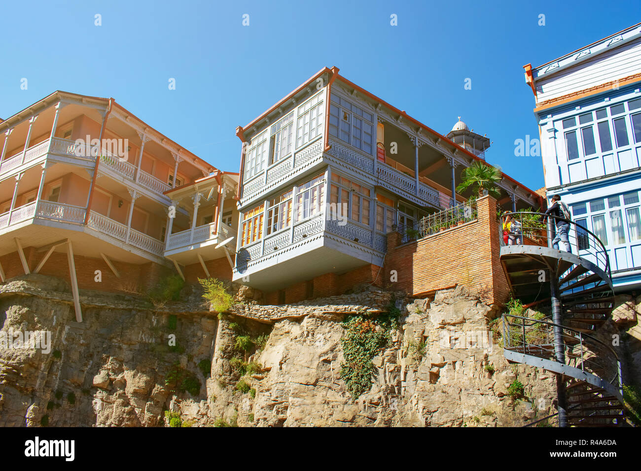 Traditional Georgian style architecture on the cliffs in Tbilisi old town. Wooden houses with colorful carved balconies Stock Photo