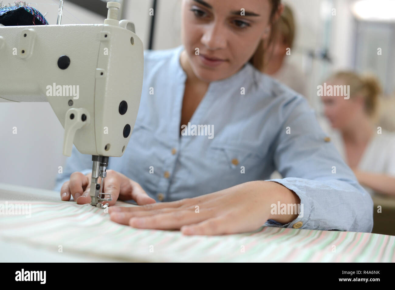 Student girl in training class working on sewing machine Stock Photo Alamy