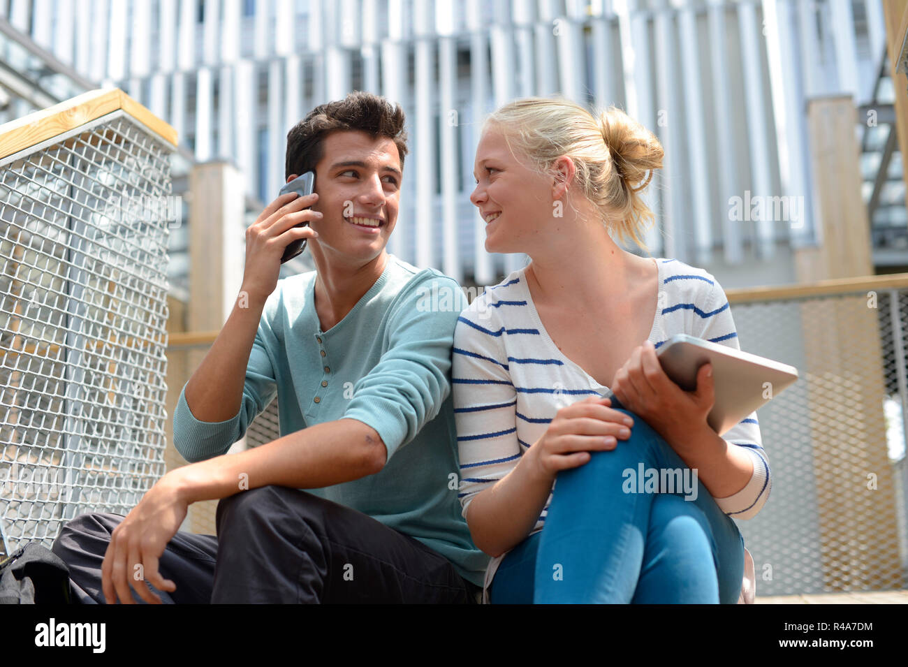 Students in school yard using digital tablet Stock Photo