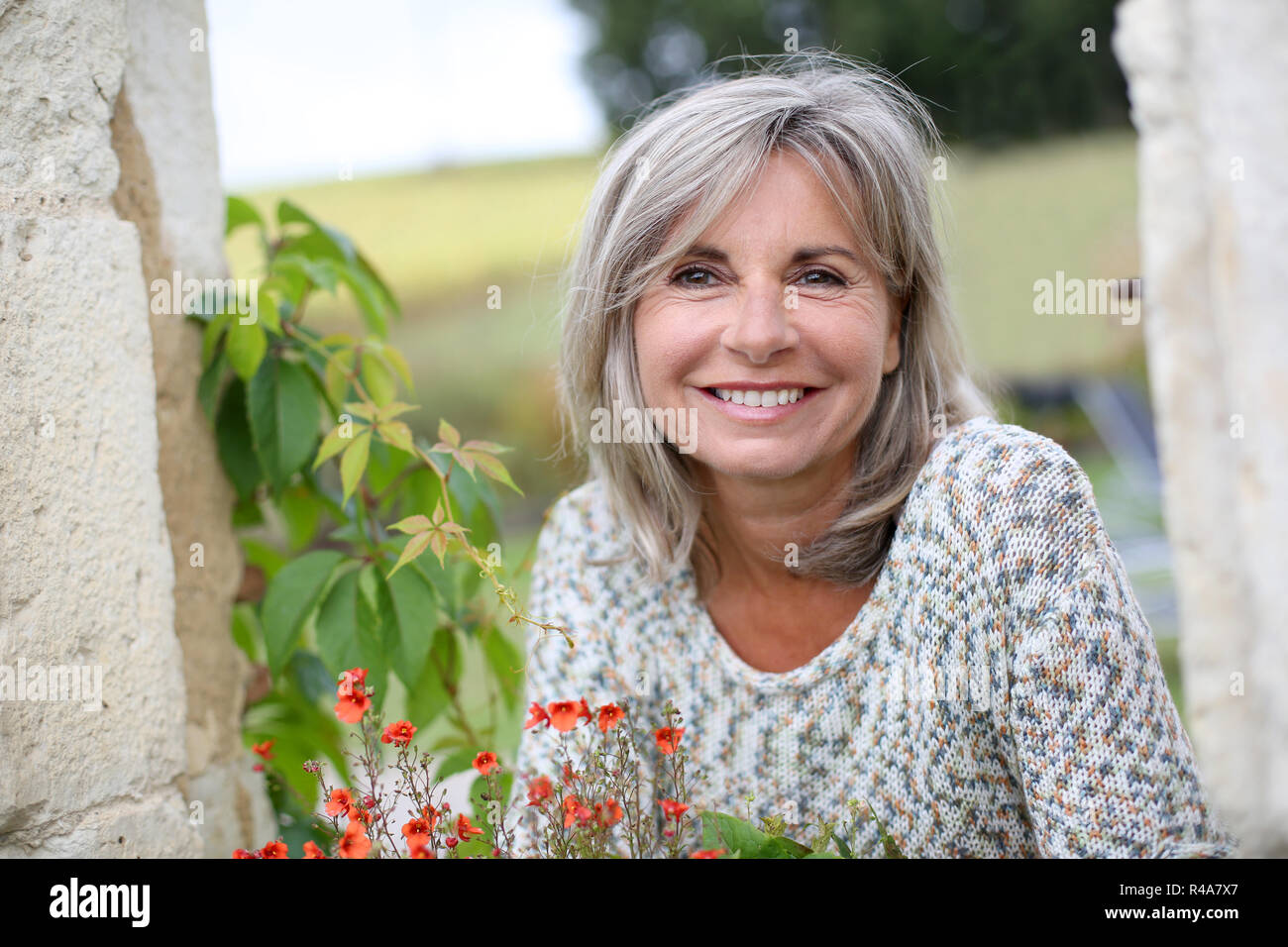 Portrait of serene mature woman in garden Stock Photo - Alamy