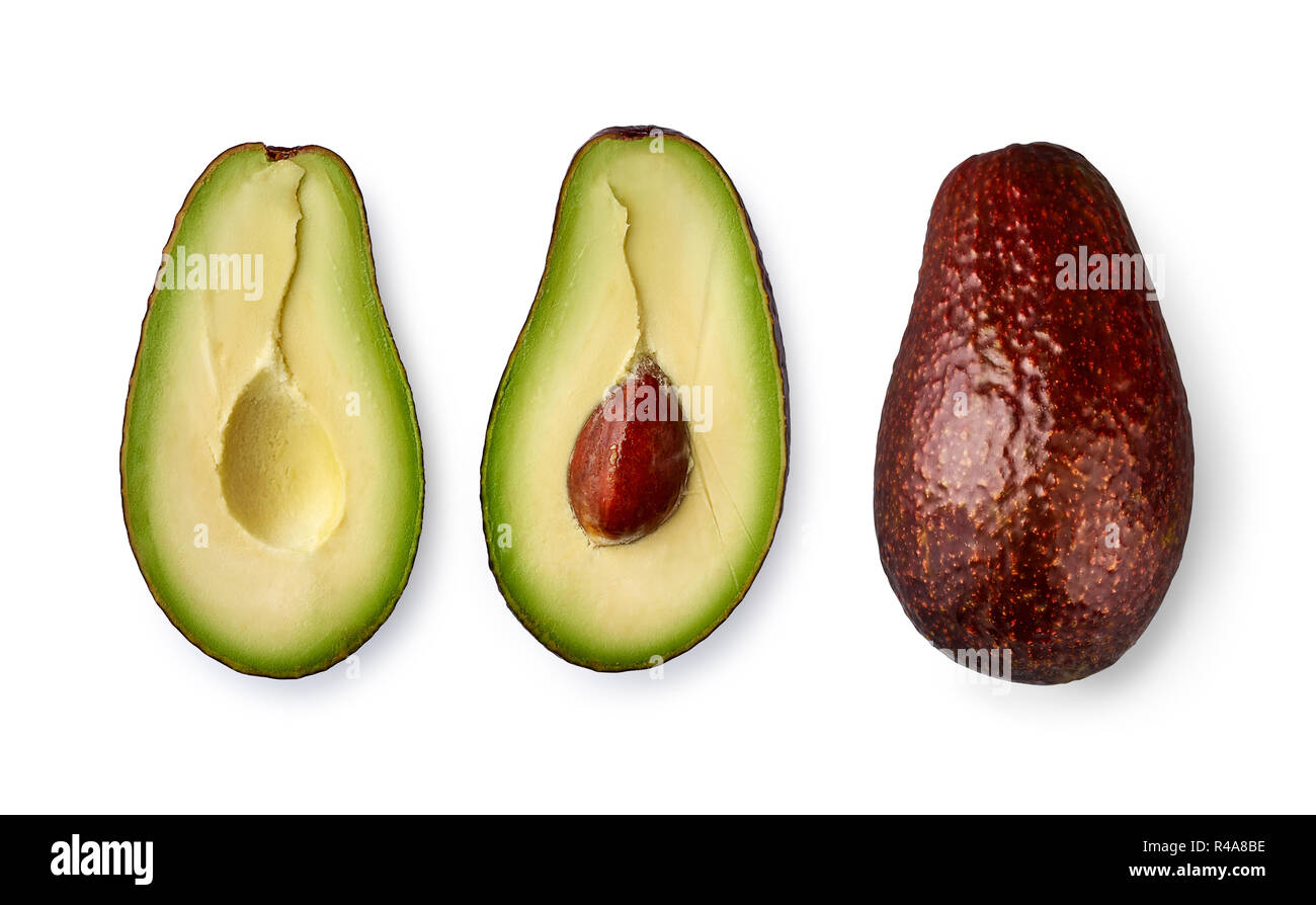 Whole avocado fruit and two halves in a row isolated on white background. Stock Photo