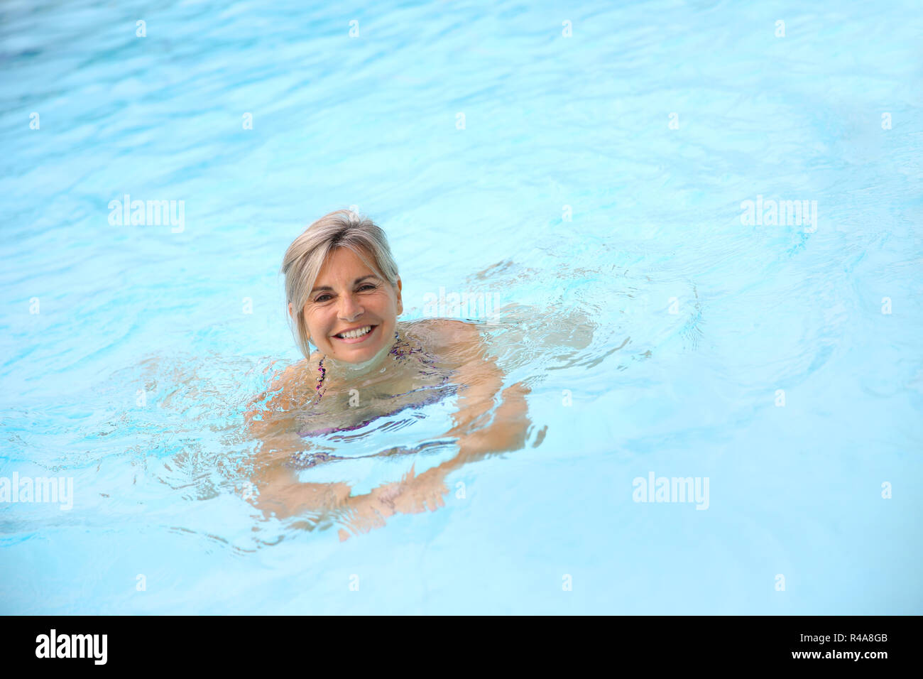 Older woman swimming in pool hi-res stock photography and images - Alamy