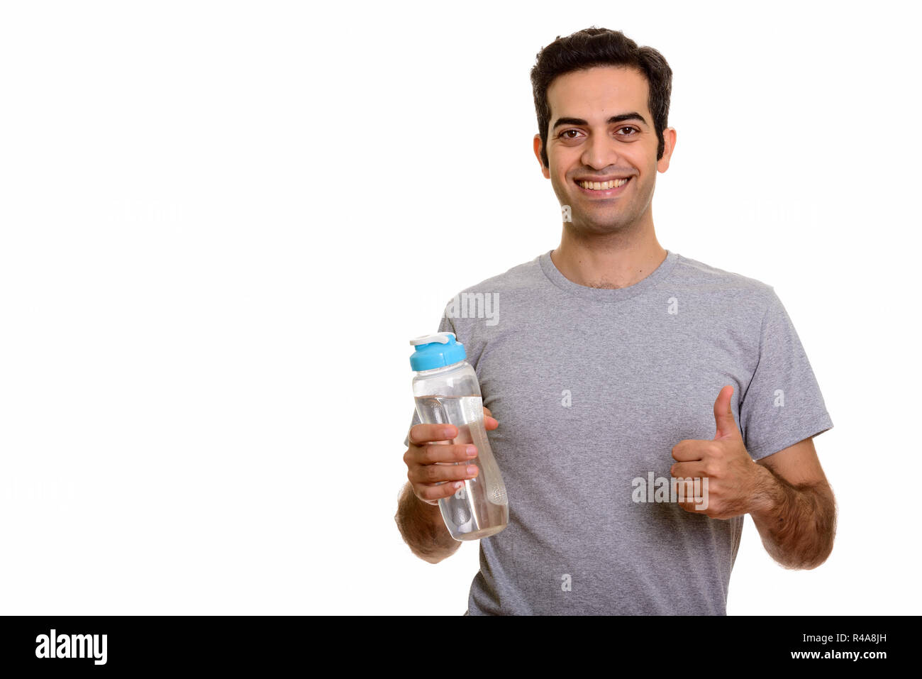 https://c8.alamy.com/comp/R4A8JH/young-happy-persian-man-holding-water-bottle-and-giving-thumb-up-R4A8JH.jpg