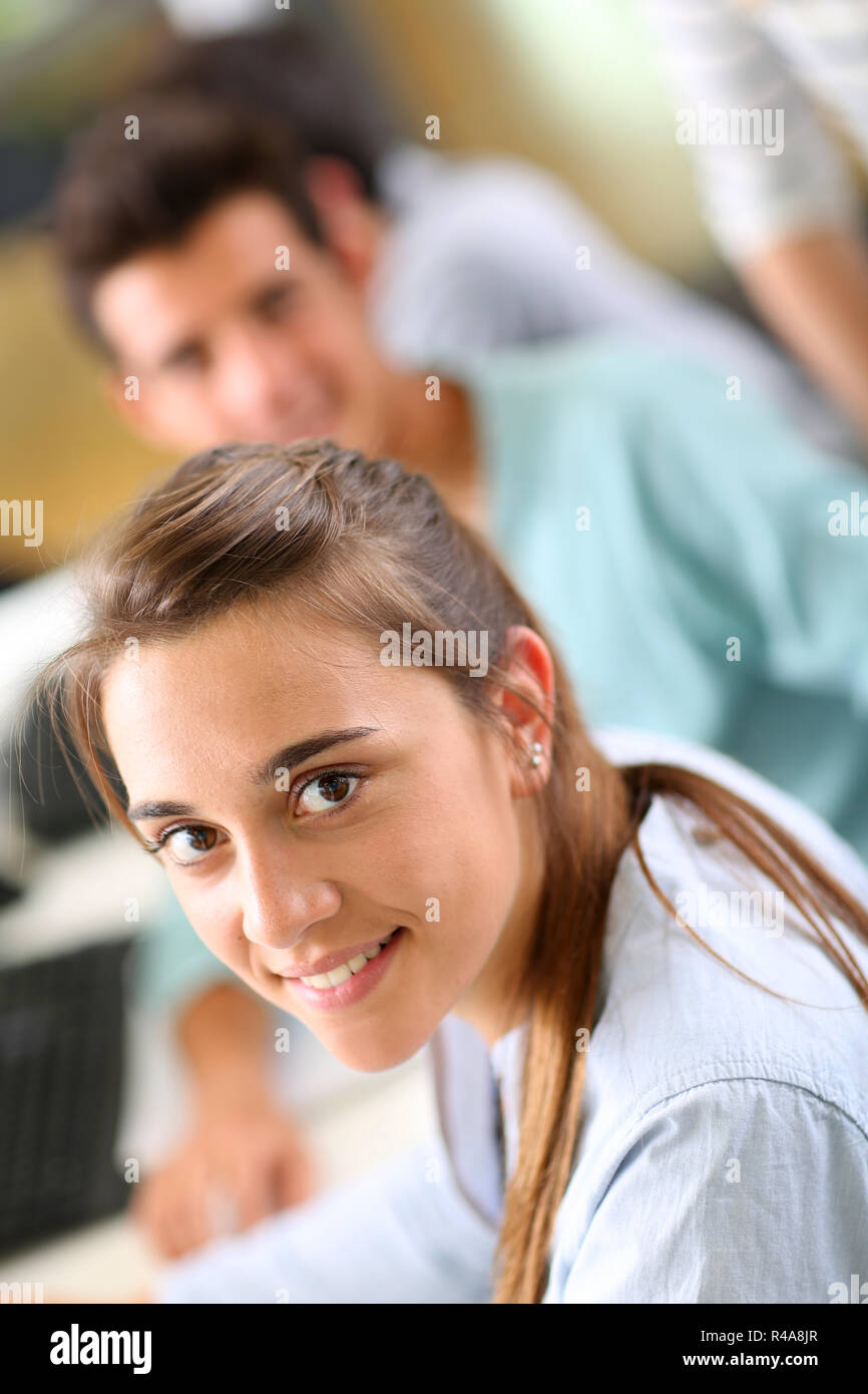 Portrait of cheerful student girl sitting in class Stock Photo - Alamy