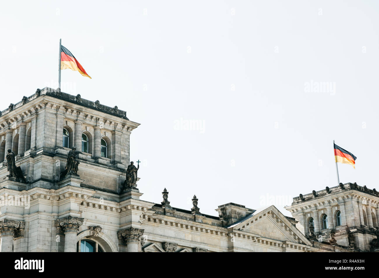 German flags over the Reichstag building in Berlin in Germany. Stock Photo