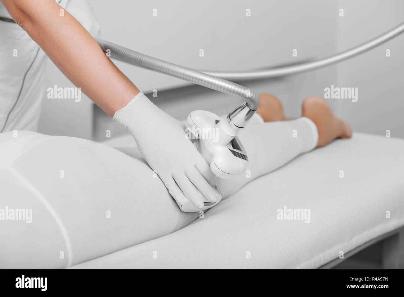 beautician doing lpg massage against cellulite on female buttocks Stock Photo