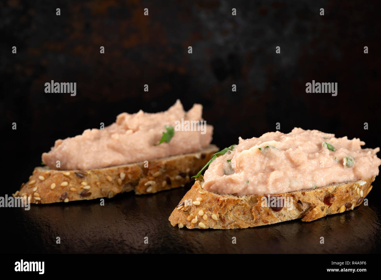 Two slices of bread with vegetable pate on a dark slate Stock Photo