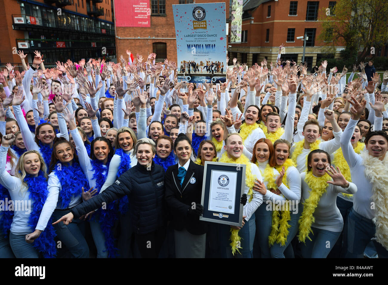 A Guiness World Record's adjudicator, Joanne Brent (centre), presents the certificate for the Guinness World record for 'the world's largest disco dance' in Waterloo, London. Stock Photo