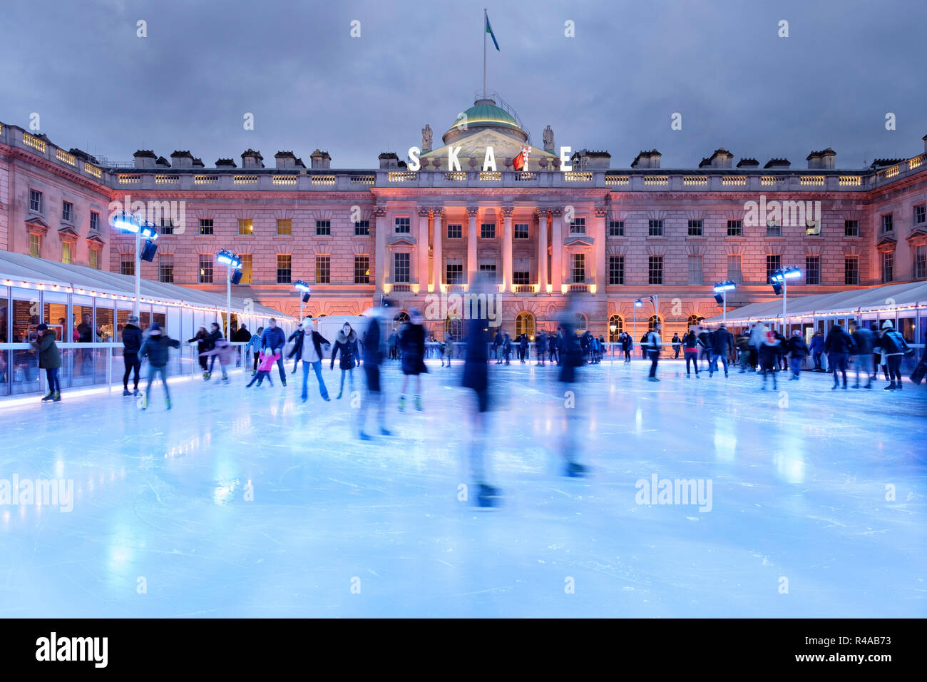 Skaters at dusk on the pop-up ice rink at Somerset House, London, England Stock Photo