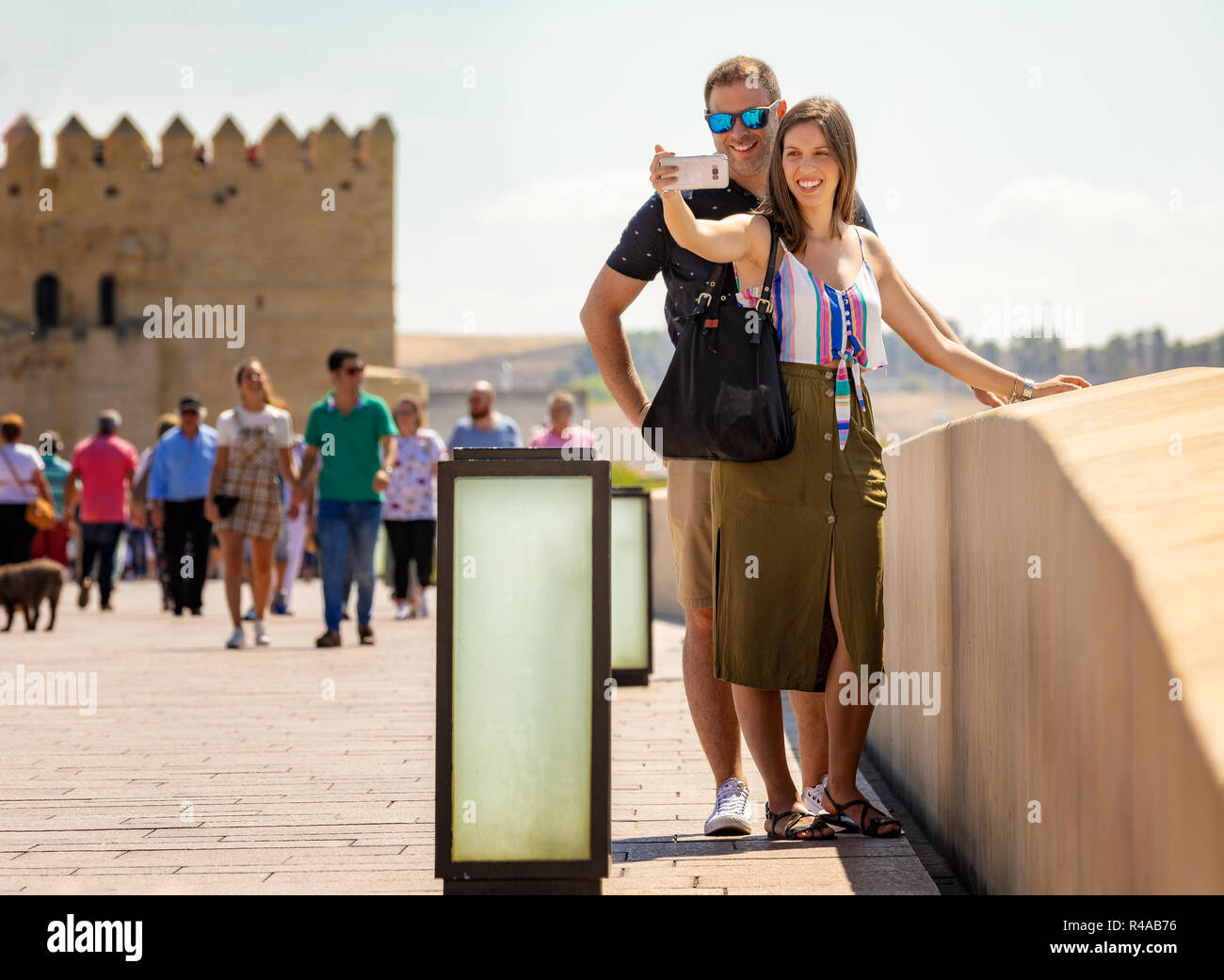 Happy couple making a selfie on a sunny day in a touristic place. Stock Photo