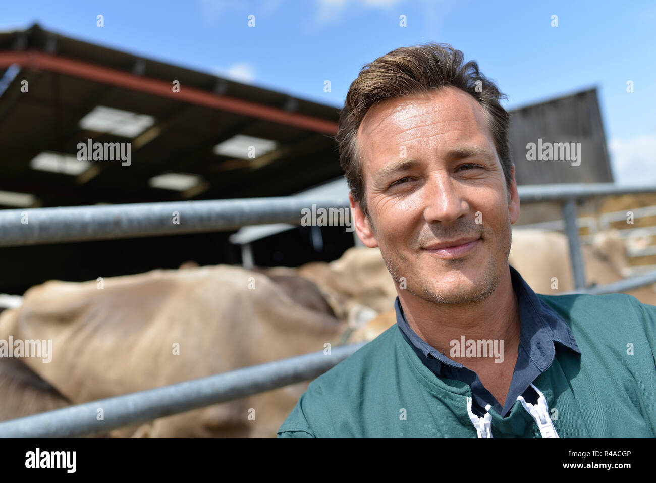 Portrait of smiling farmer standing by barn Stock Photo - Alamy