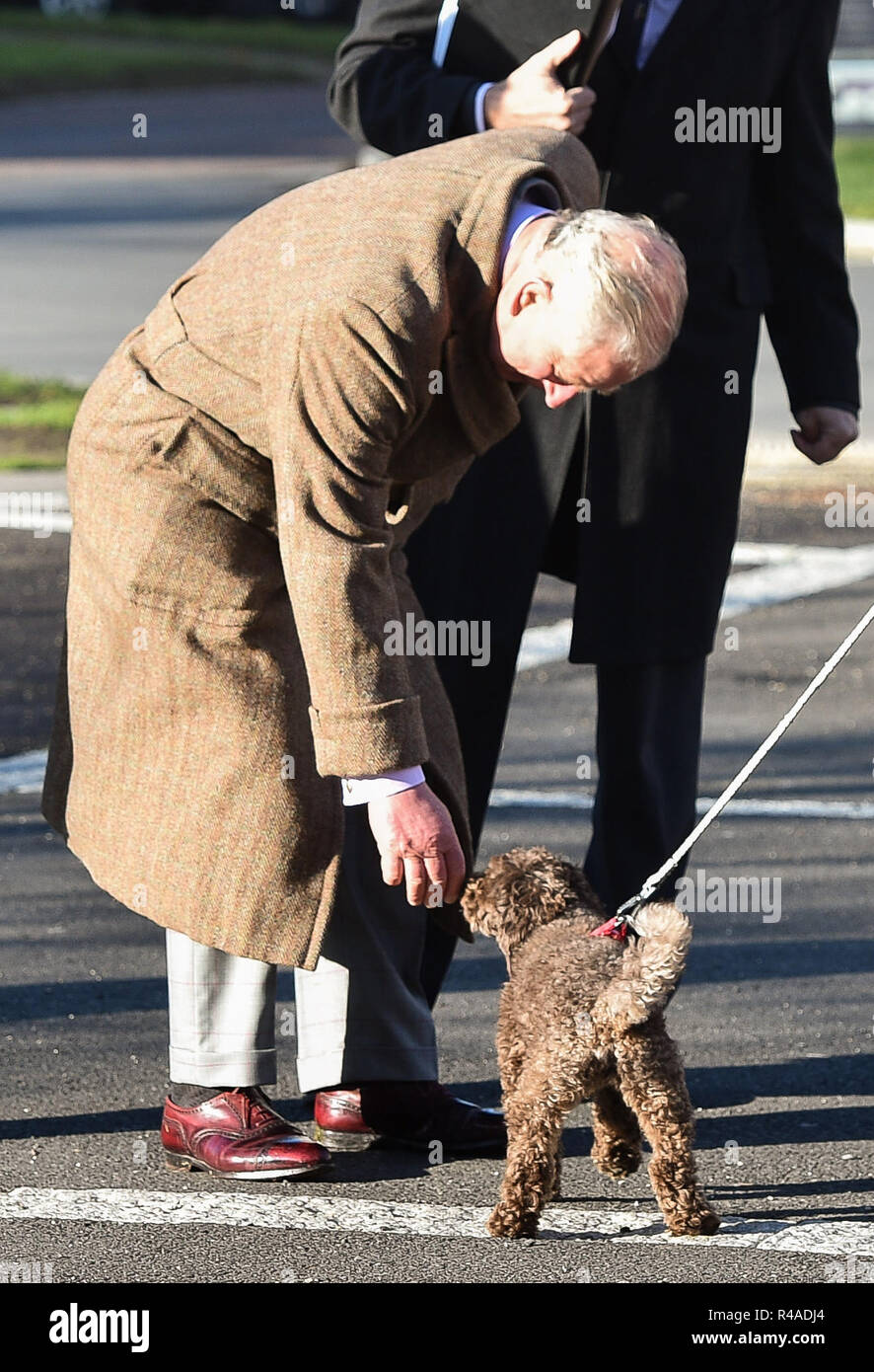 The Prince of Wales greets a dog as he arrives at Poundbury, Dorset, where he is opening Yarlington Housing Group's new Extra Care housing development and Dorchester Community Church. Stock Photo