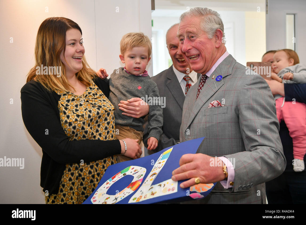 The Prince of Wales receives a birthday card from one-year-old Oliver Knight and his mother Courtney Critchell, made by the toddlers in the church group in Dorchester Community Church, Poundbury, Dorset. Stock Photo