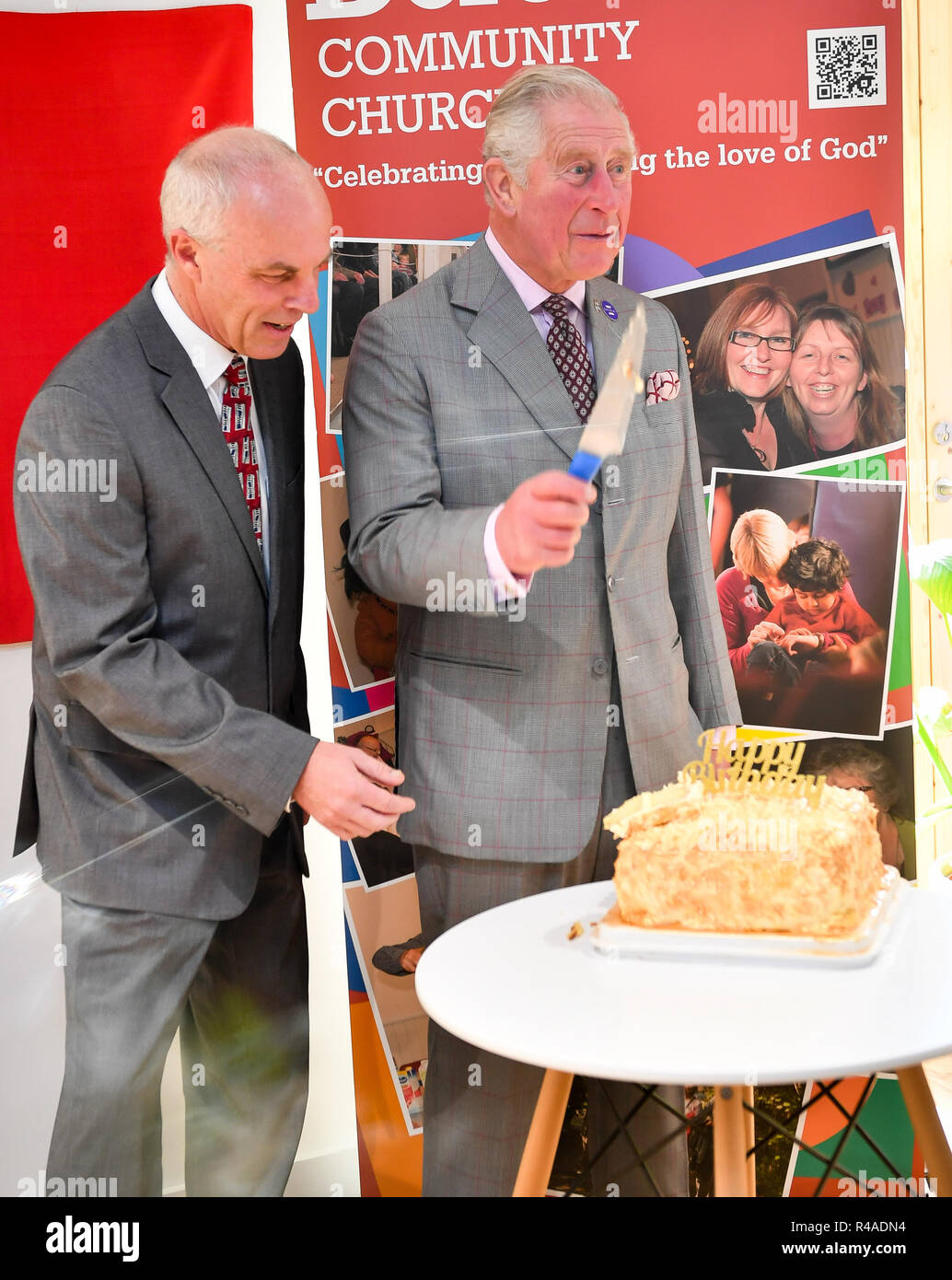 The Prince of Wales cuts a birthday cake with pastor Roger Frapwell in Dorchester Community Church, Poundbury, Dorset, where the Prince is opening the church and Yarlington Housing Group's new Extra Care housing development. Stock Photo