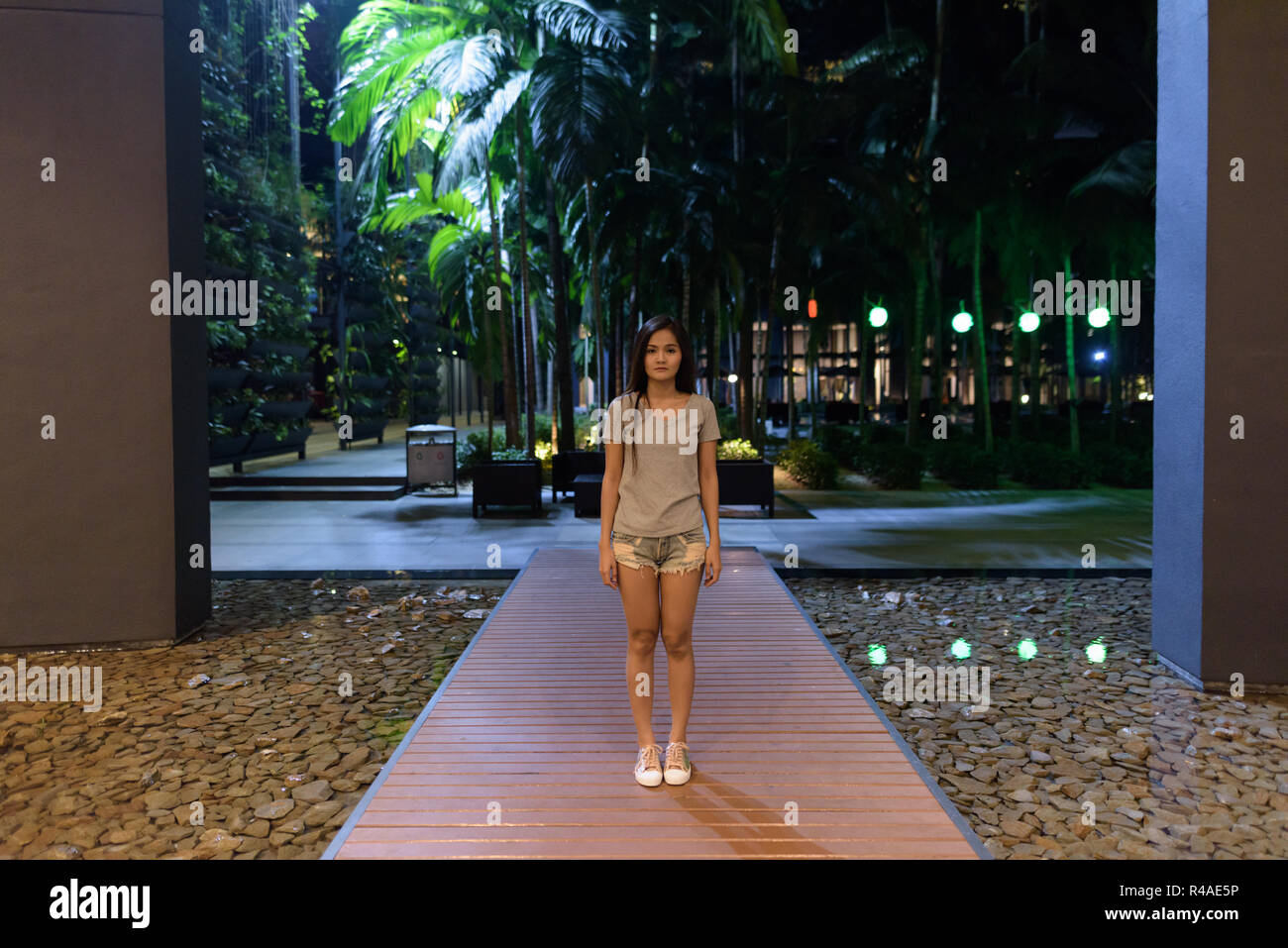 Young beautiful Asian woman standing on wooden boardwalk of the  Stock Photo