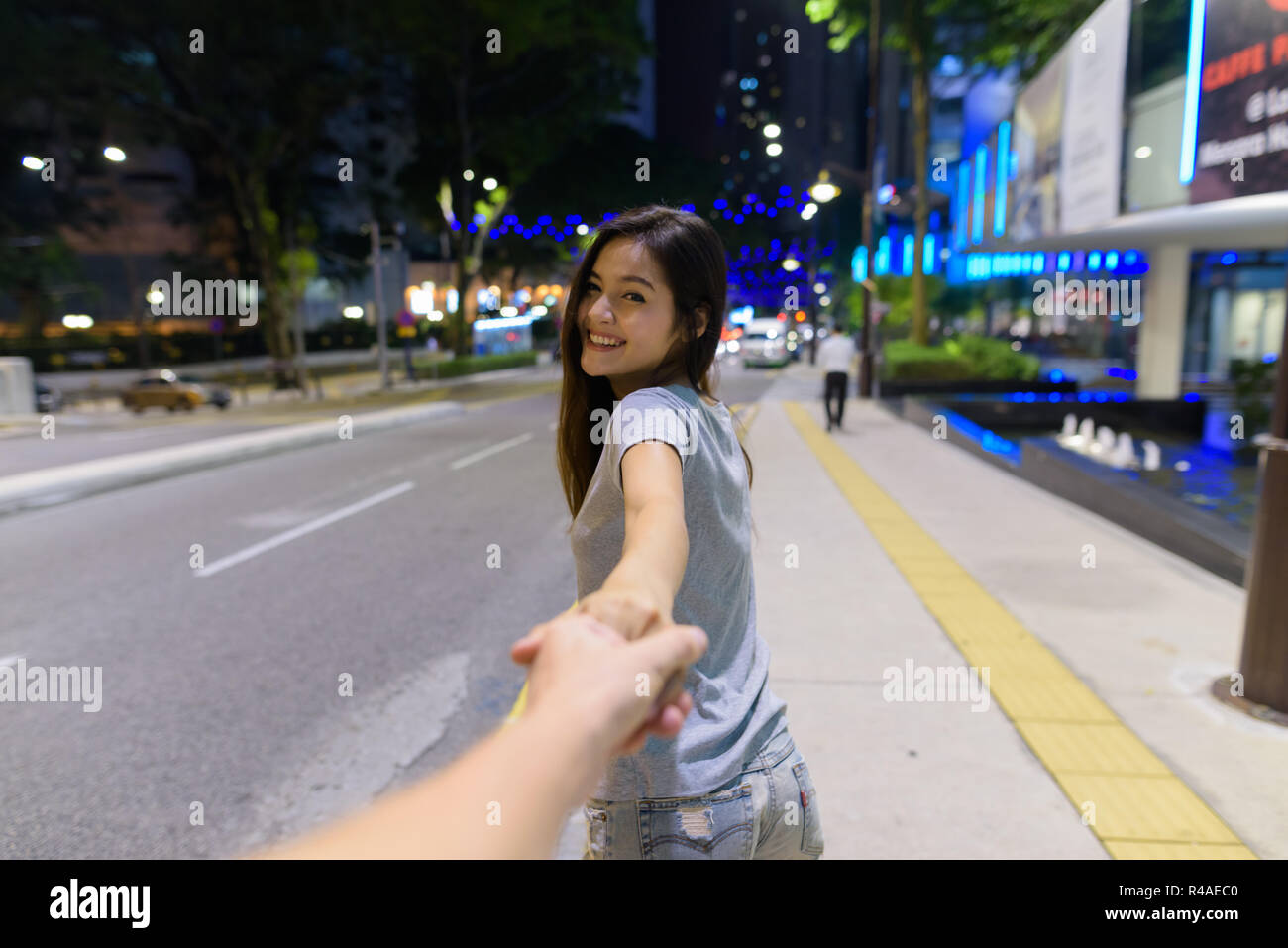 Asian couple holding hands hi-res stock photography and images - Alamy