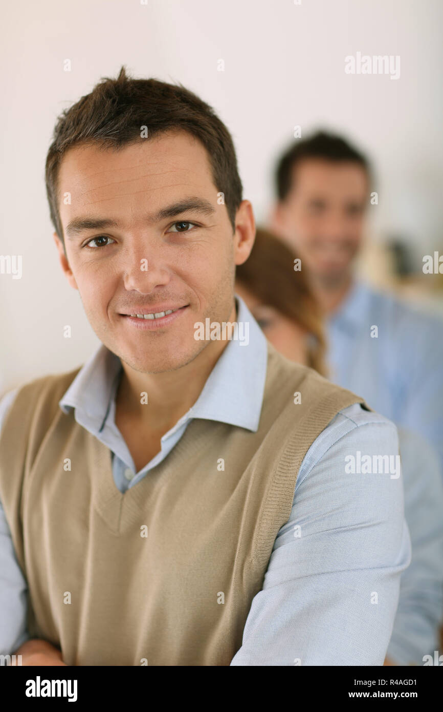 Handsome man standing in front of business team Stock Photo - Alamy