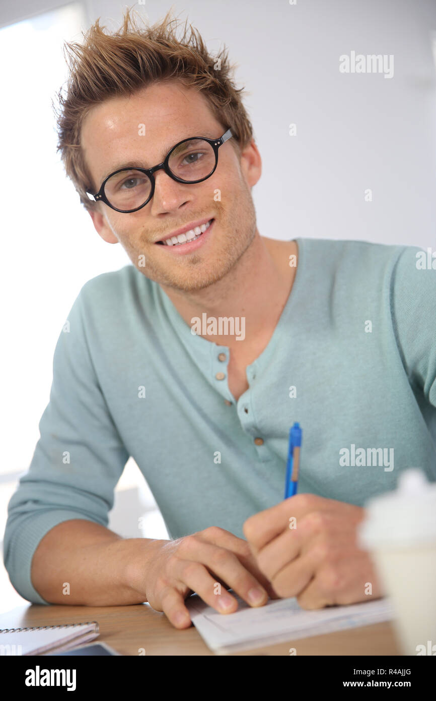 Portrait of young man filling in application form Stock Photo - Alamy