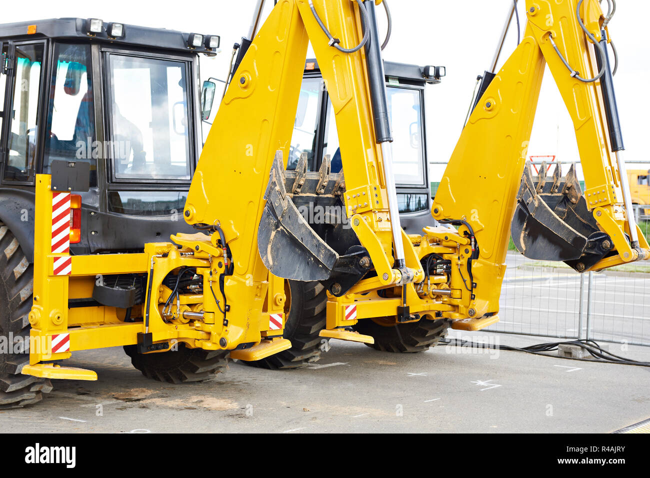 Two yellow excavators on wheels Stock Photo - Alamy