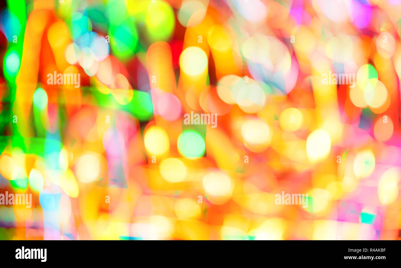 Defocused abstract multicolored bokeh lights background. Yellow, purple, green, orange colors Stock Photo