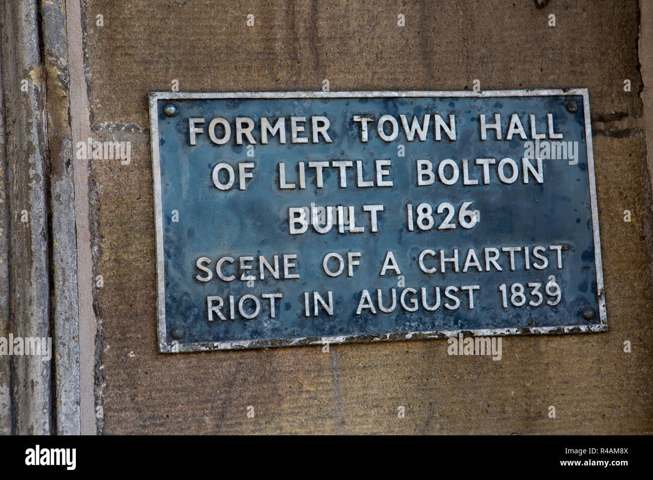 Plaque explains the old town hall building of Little Bolton in Lancashire UK Stock Photo