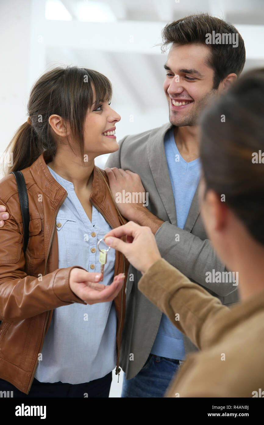 Happy young couple getting key of their new place Stock Photo - Alamy