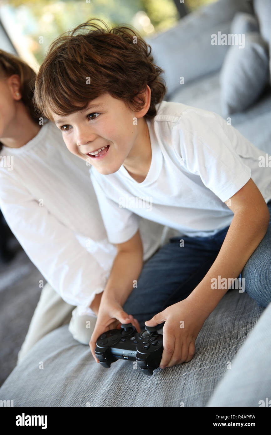 Kids at home playing video game Stock Photo