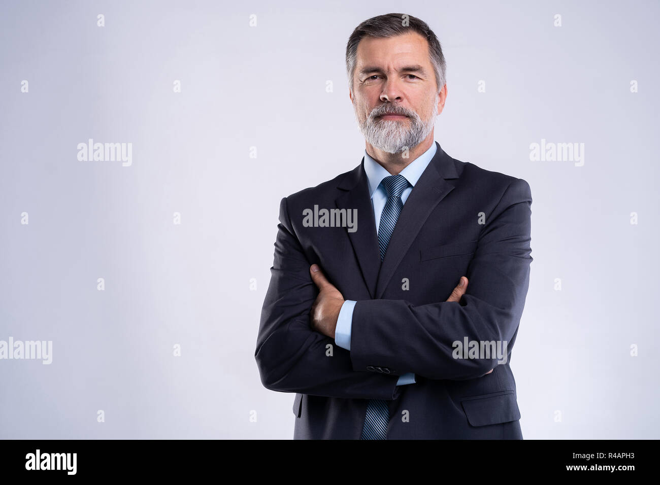 Happy satisfied mature businessman looking at camera isolated on white ...