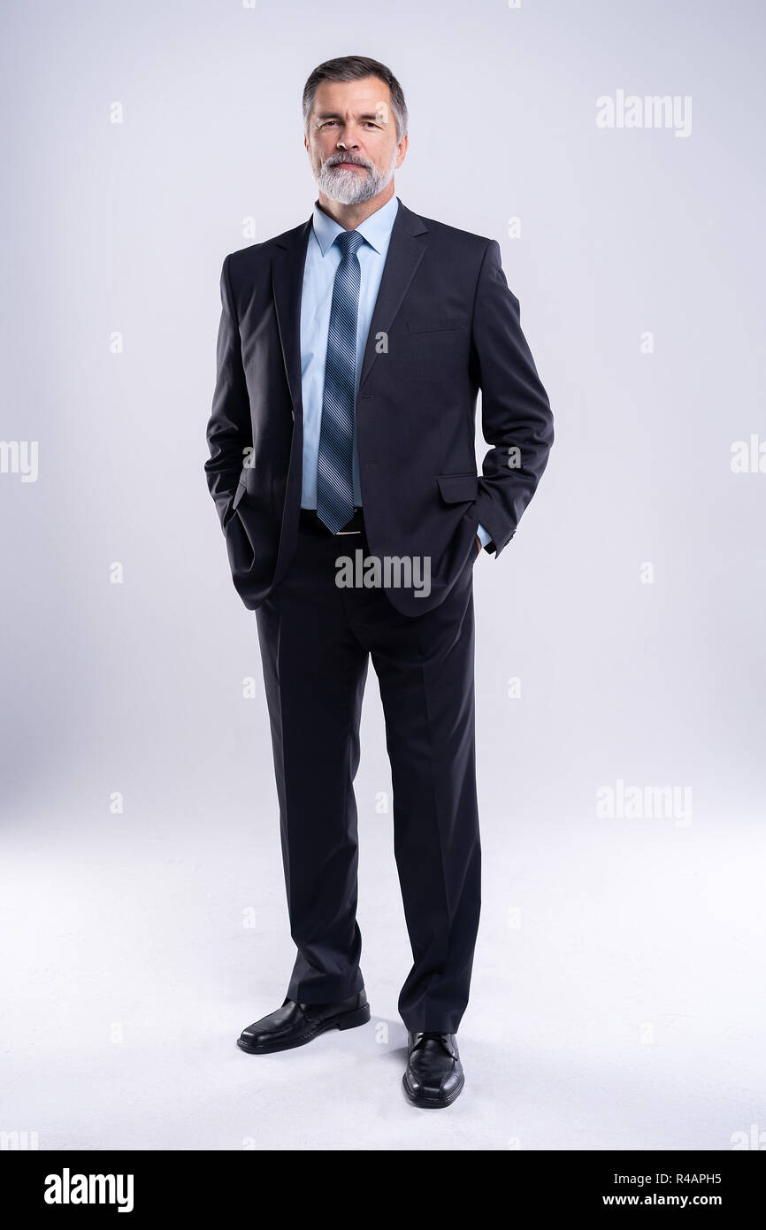 Full length portrait of confident mature businessman in formals ...