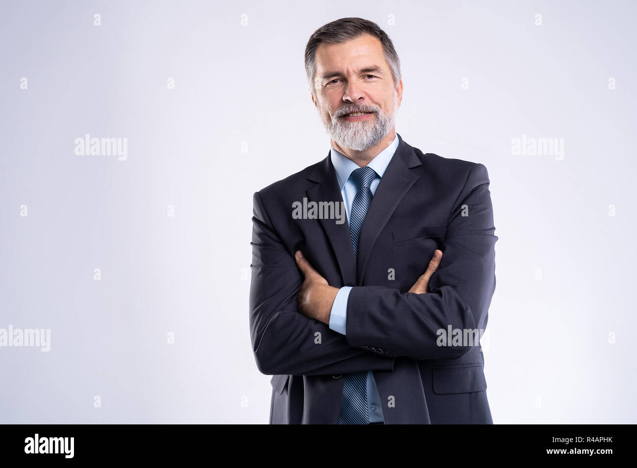 Happy satisfied mature businessman looking at camera isolated on white ...