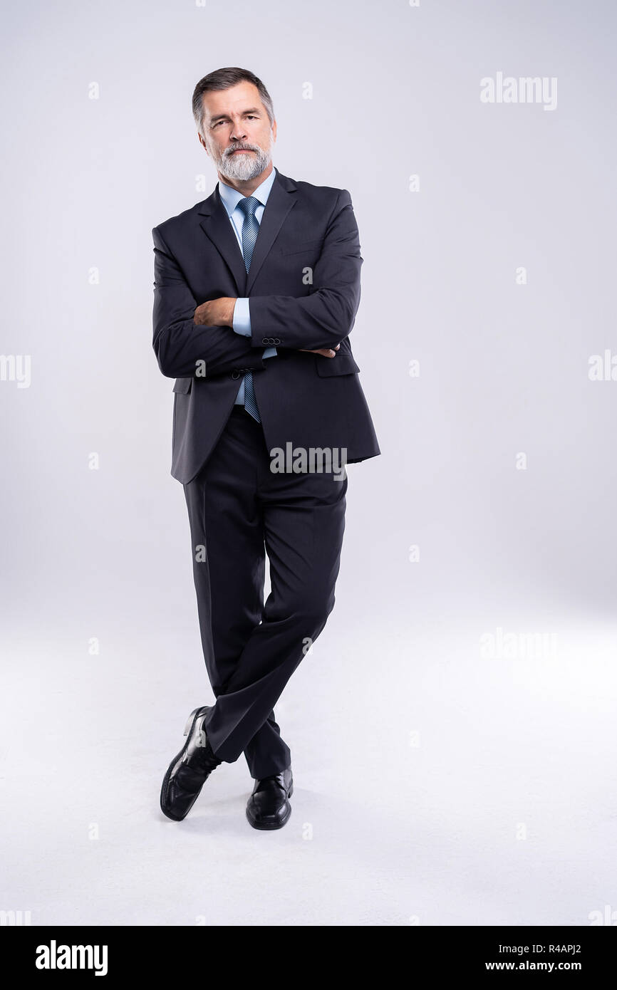 Full length portrait of confident mature businessman in formals ...