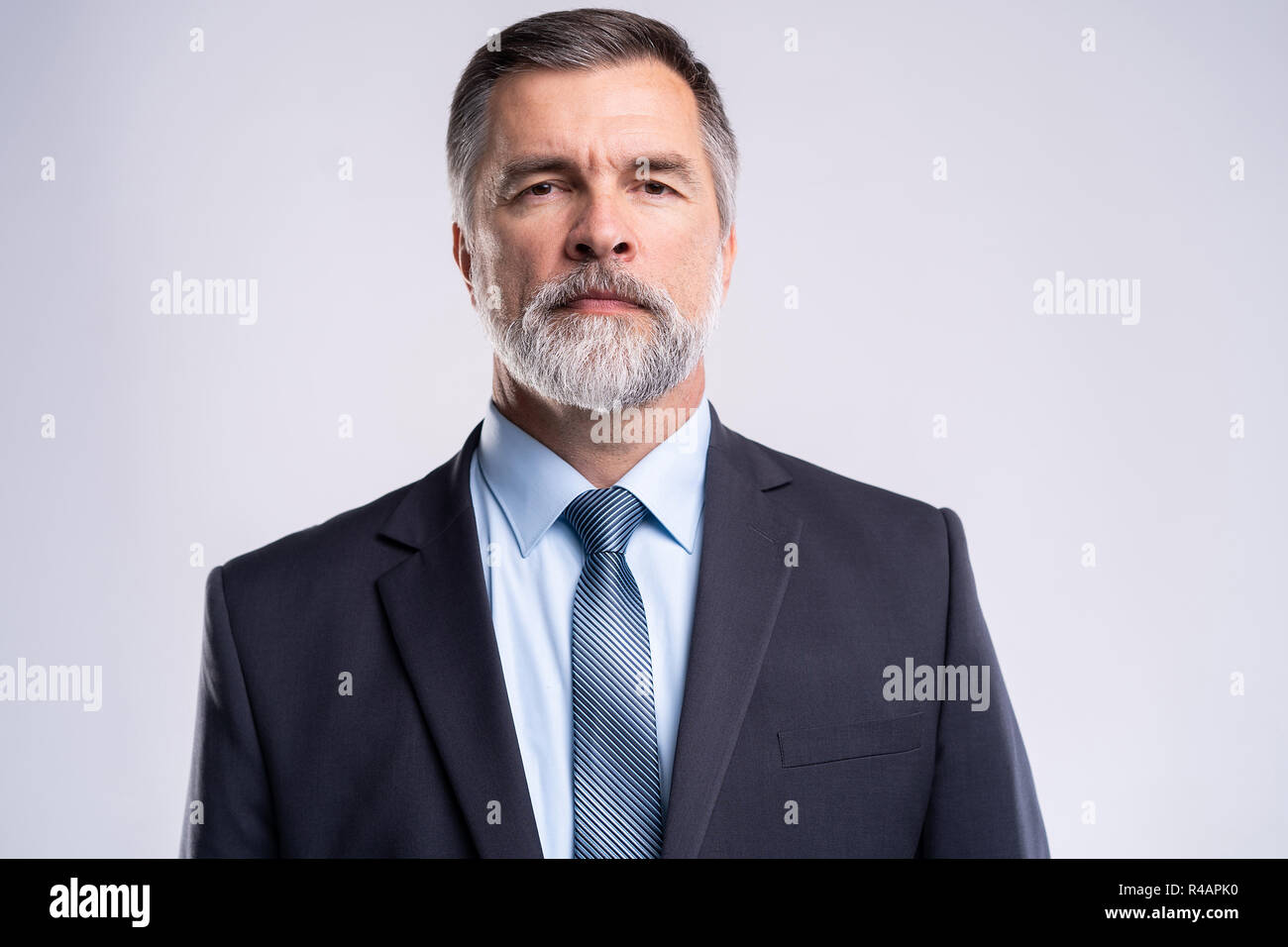 Happy satisfied mature businessman looking at camera isolated on white ...