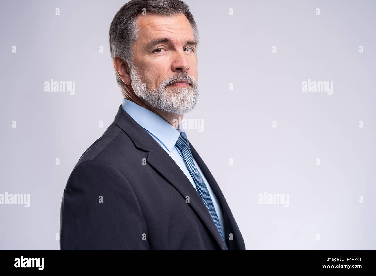 Happy satisfied mature businessman looking at camera isolated on white ...