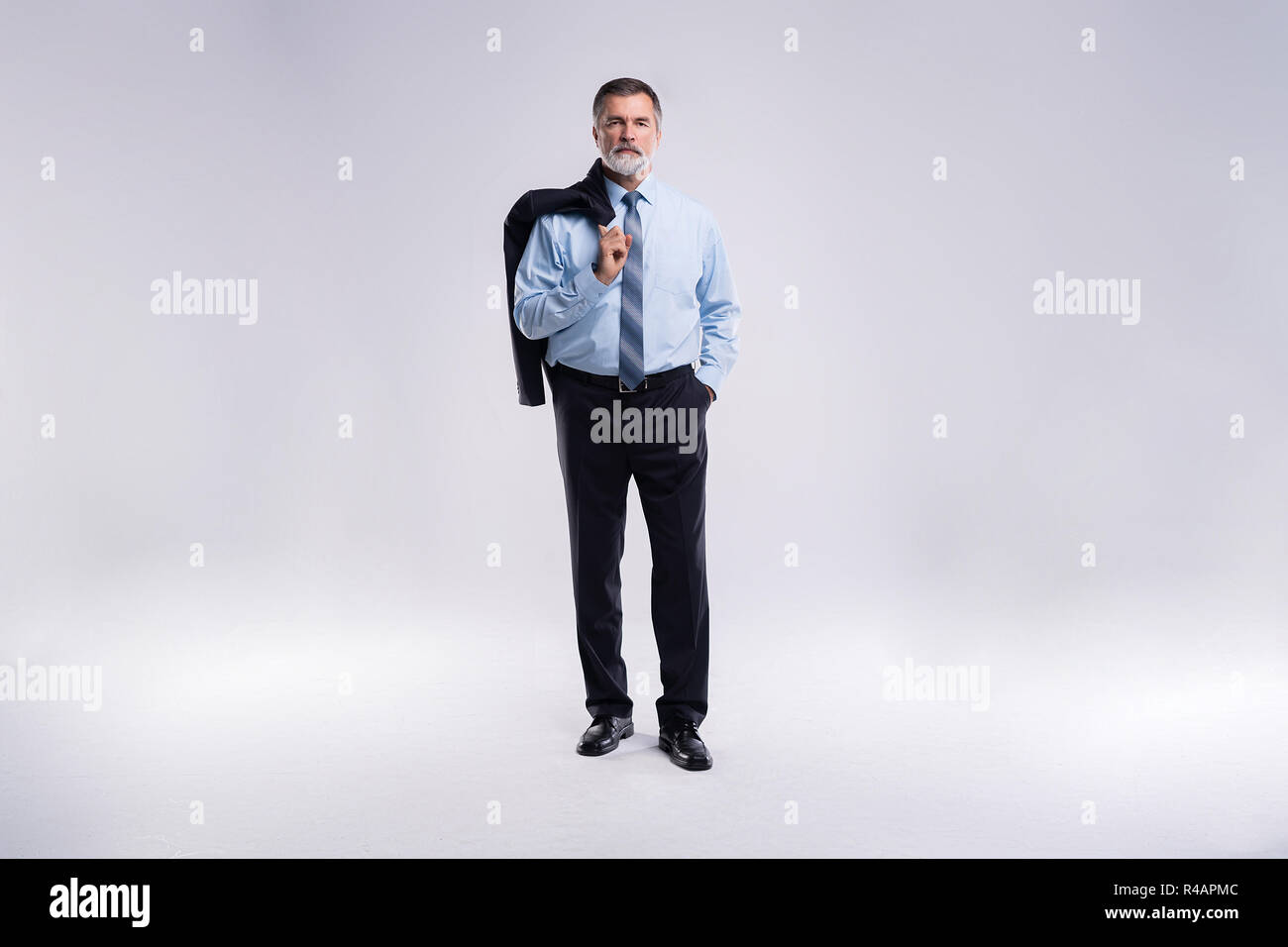 Full length portrait of confident mature businessman in formals ...