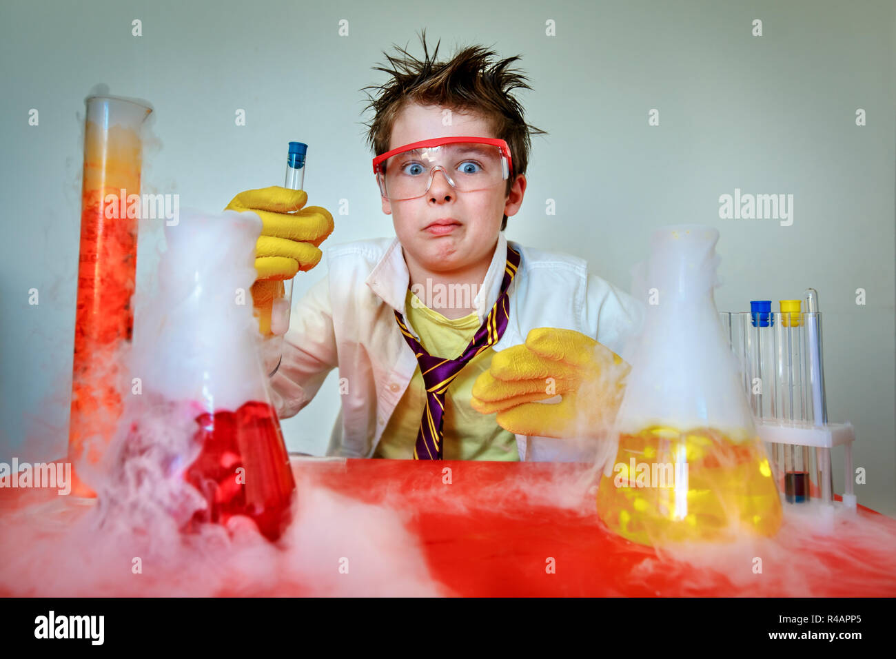 Crazy young scientist performing experiments in lab Stock Photo
