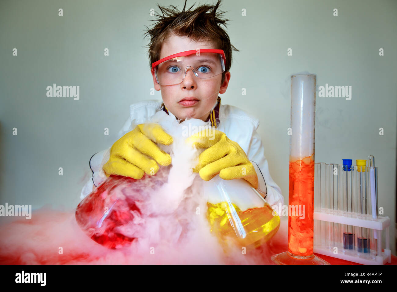 Crazy scientist performing experiments in lab Stock Photo