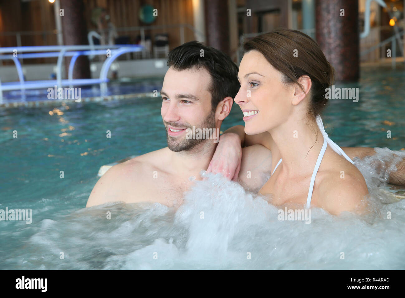 Couple enjoying bath in spa center jacuzzi Stock Photo - Alamy