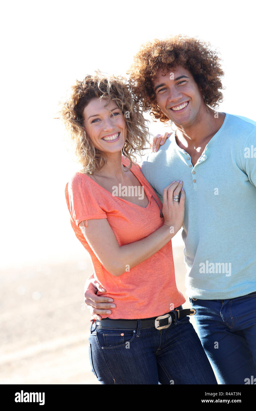 Smiling couple walking on the beach Stock Photo - Alamy