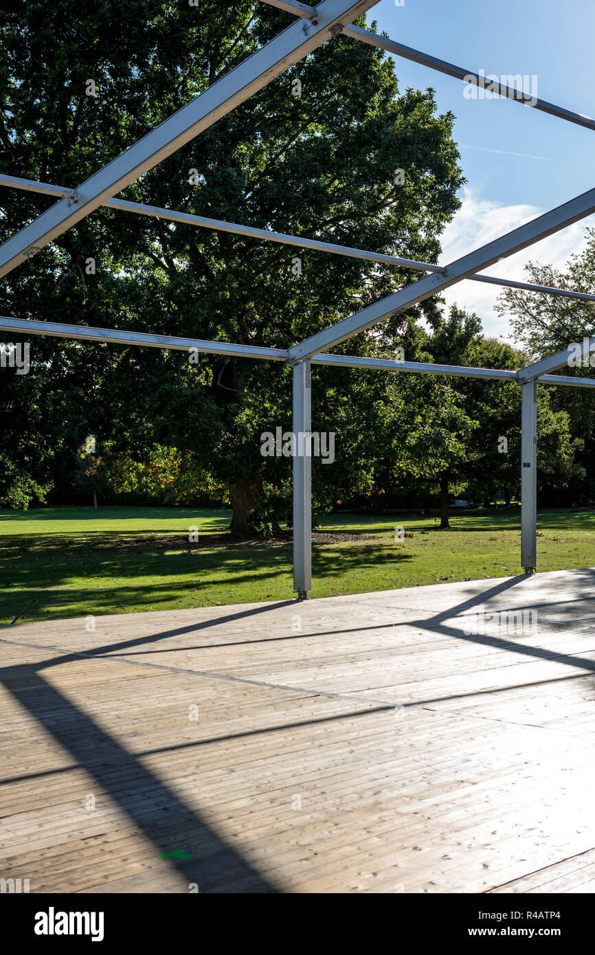The frame of a temporary building set up in a large garden, a marquee
