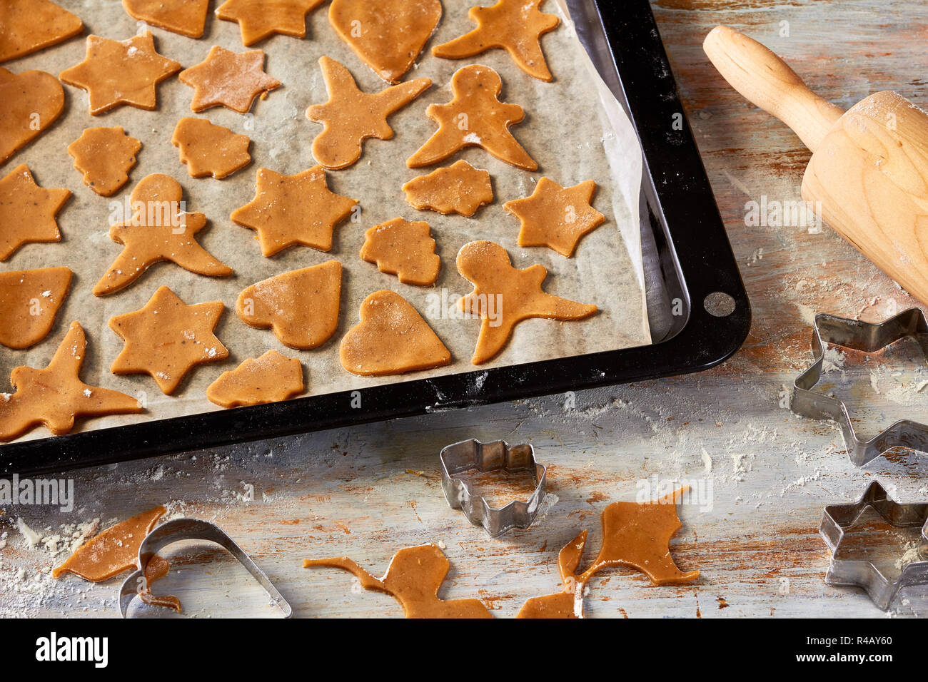 Different form raw gingerbread cookies on oven-tray Stock Photo