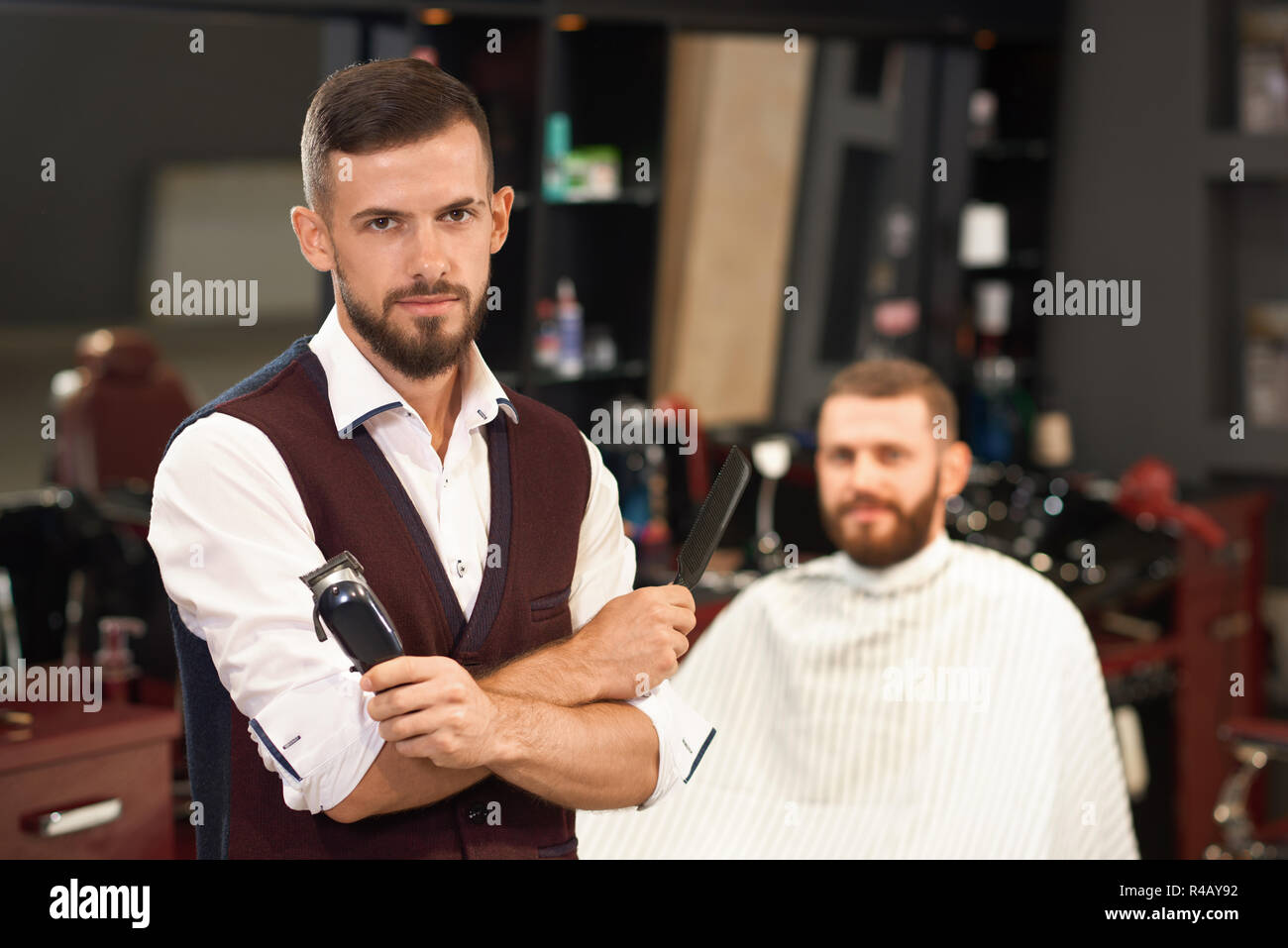 Front View Of Stylish Barber With Folded Arms Looking At Camera In