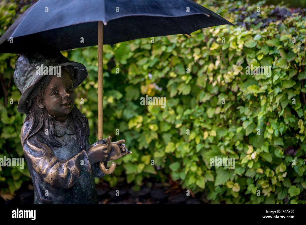 Statue of a little girl under an umbrella. Ukraine October 12, 2018 Stock Photo