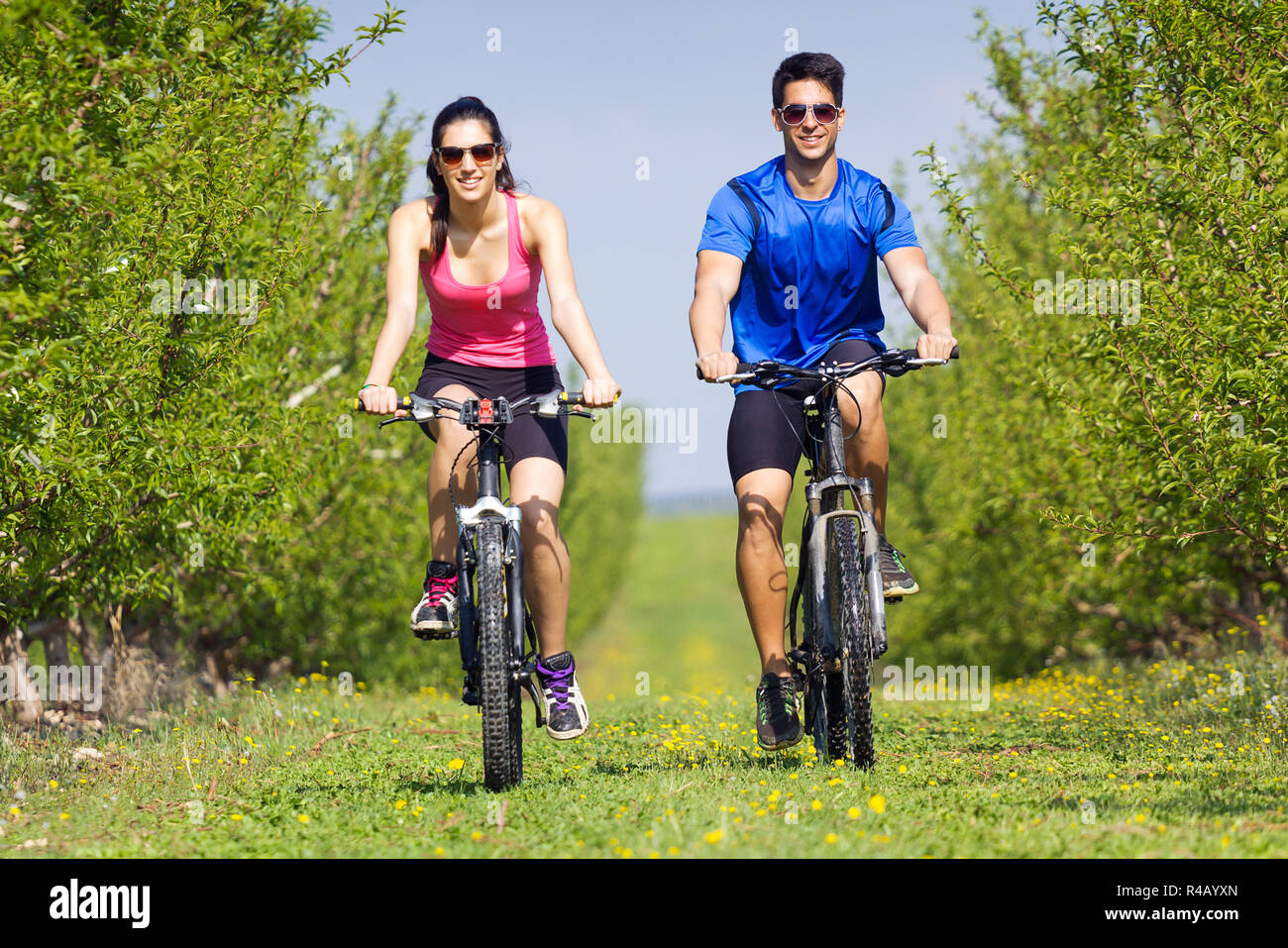 Happy Bike Ride Happy young couple on a bike ride in the countryside Stock Photo - Alamy