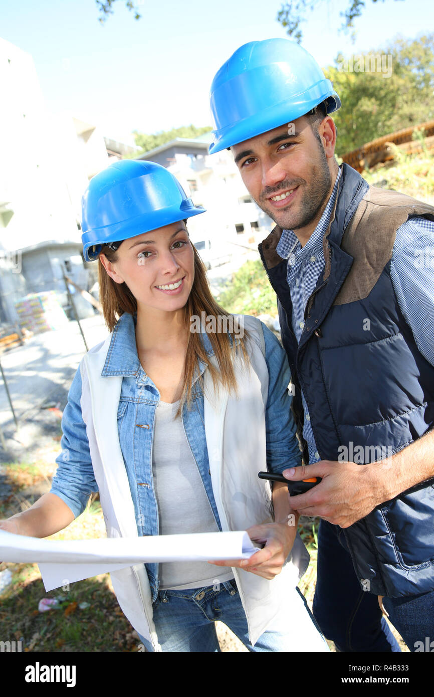 Smiling architects standing on construction site Stock Photo - Alamy