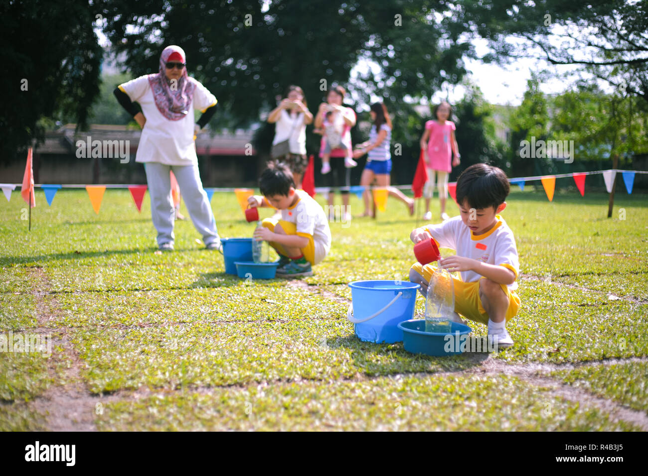 Children compete in fillthebottle game during their kindergarten