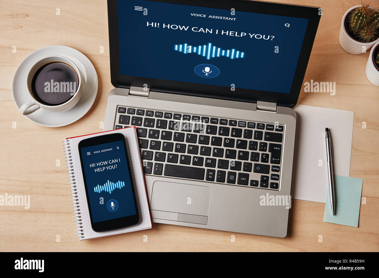 Voice assistant concept on laptop and smartphone screen over wooden table. All screen content is designed by me. Flat lay Stock Photo